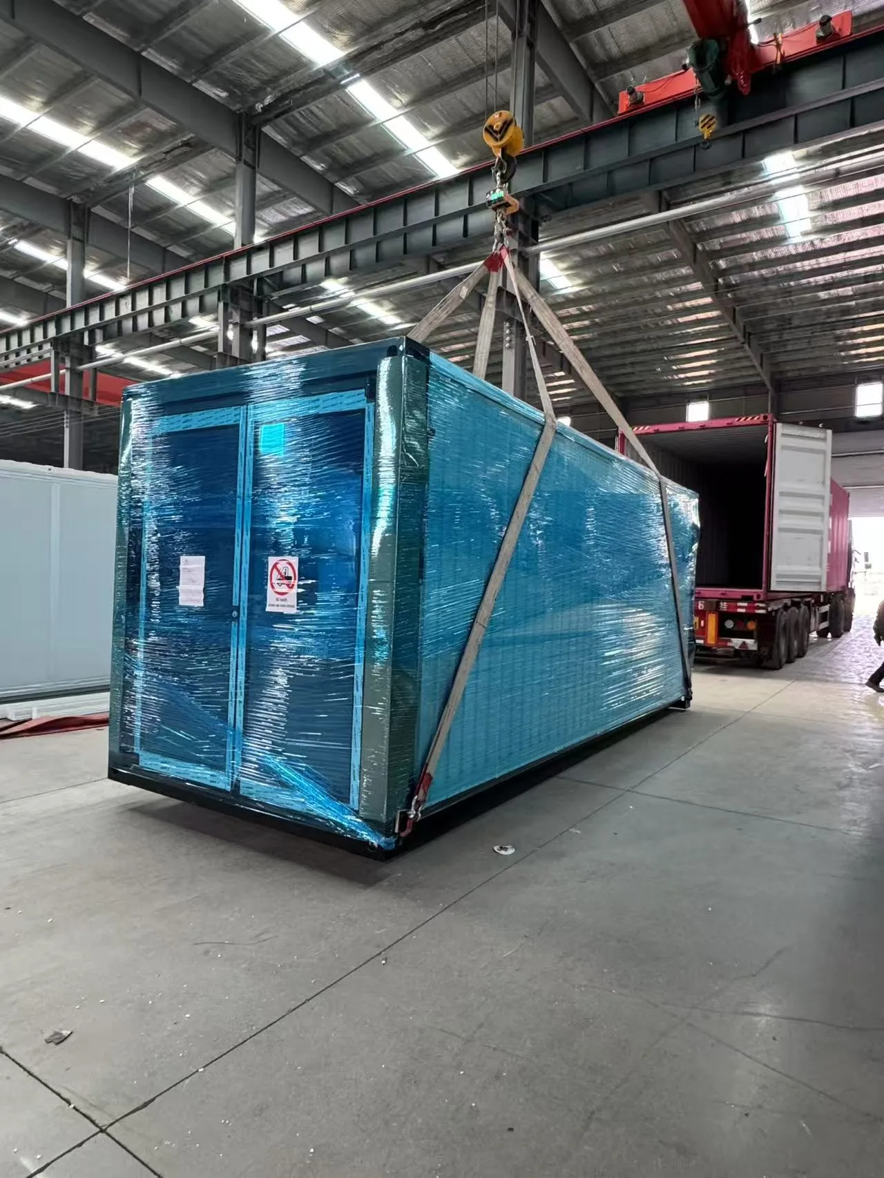 flat-pack packing of an expandable container house before shipping