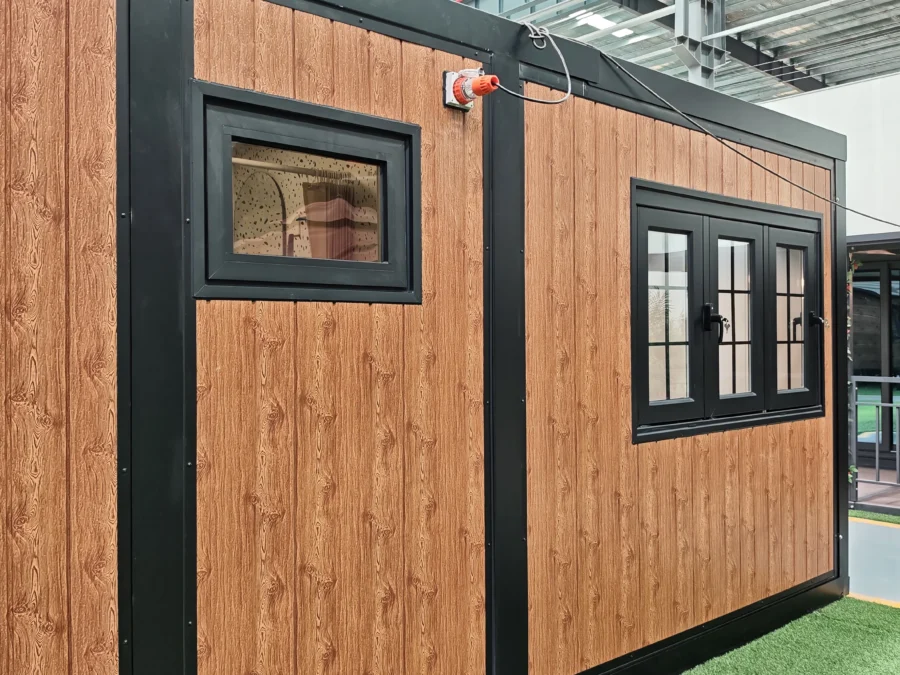 10ft expandable container house with wood-grain facade and black-framed windows