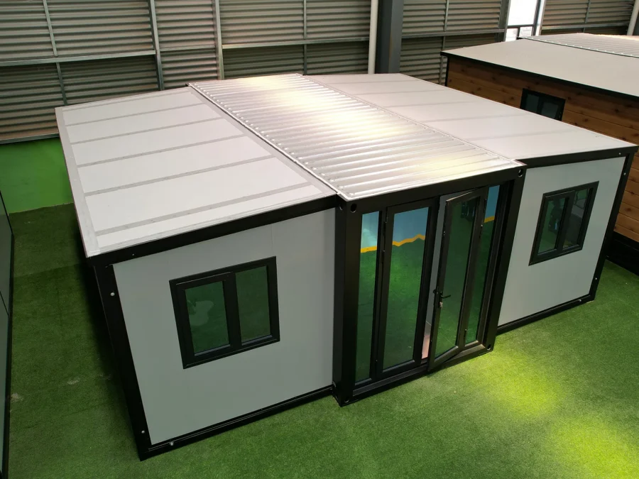 20ft expandable container house with roof panels half-folded, showing the expansion mechanism