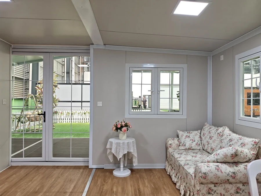 20ft container house living room with floral sofa opening onto the terrace