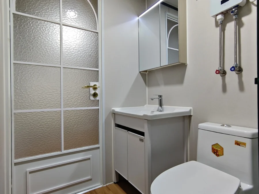20ft container house bathroom with arched mirror and classic fittings