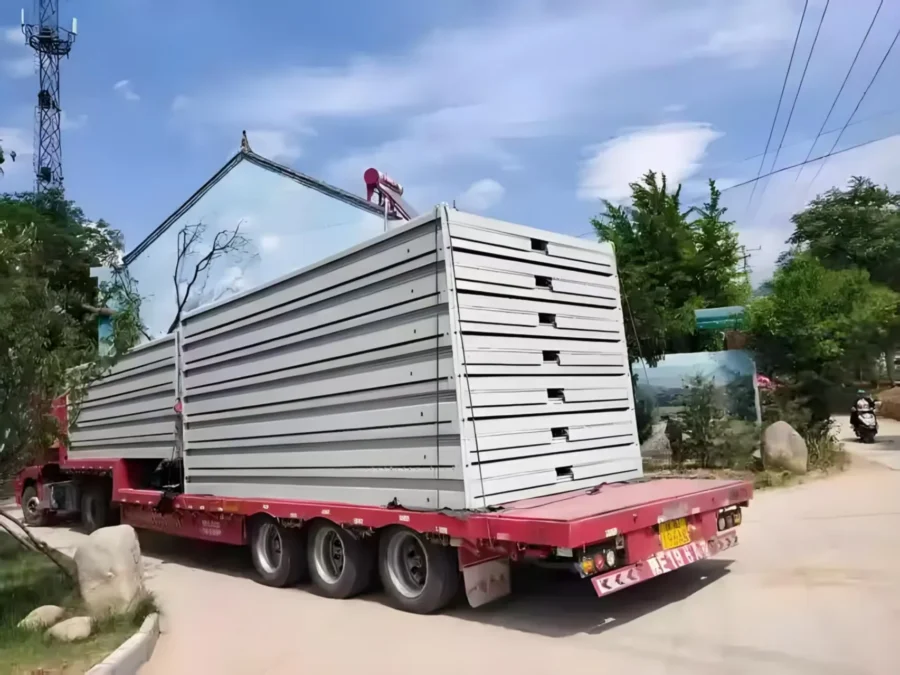 Folded flat-pack container house units loaded on a truck for delivery